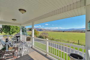 Wooden deck featuring a mountain view and a rural view