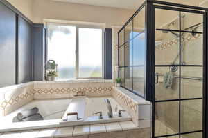 Bathroom featuring shower with separate bathtub