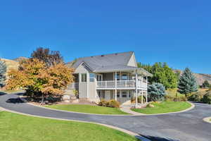 Exterior space featuring a balcony, a mountain view, and a front yard