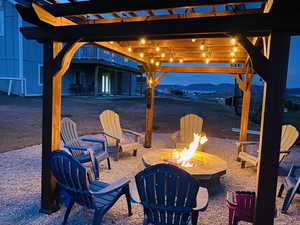 View of patio with a mountain view and a fire pit
