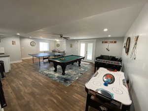 Rec room with ceiling fan, dark wood-type flooring, pool table, and french doors