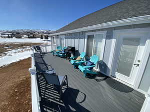 Snow covered deck featuring area for grilling