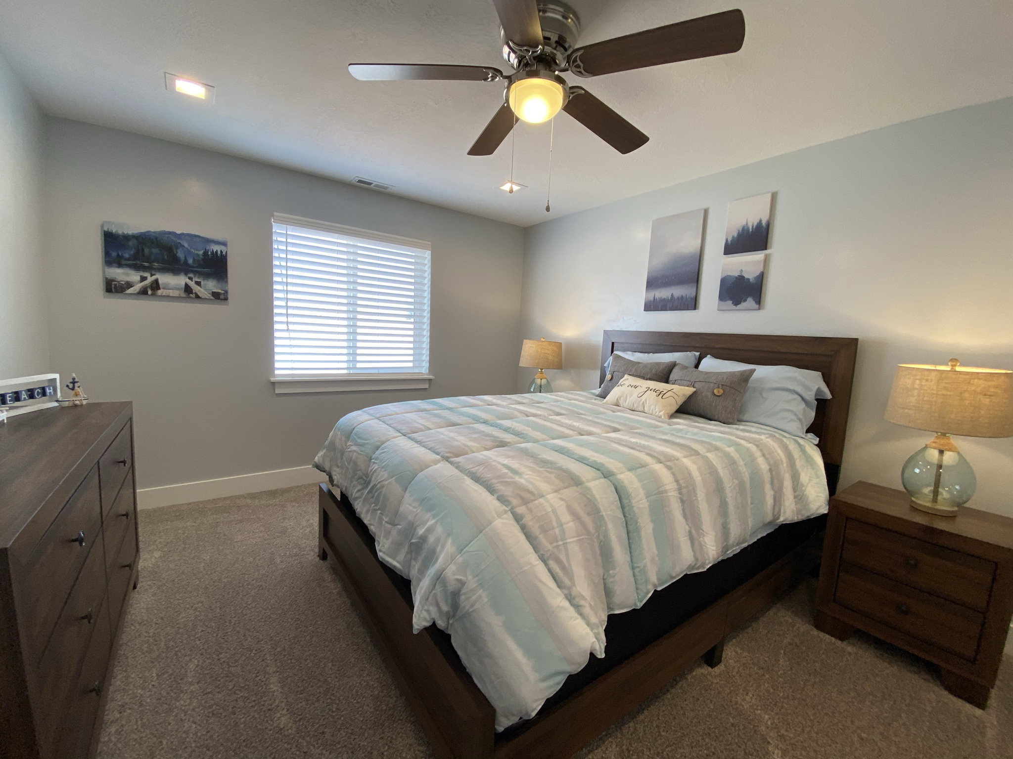 Carpeted bedroom with ceiling fan