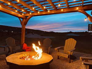 Patio terrace at dusk featuring an outdoor fire pit