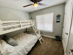 Bedroom featuring ceiling fan and carpet flooring