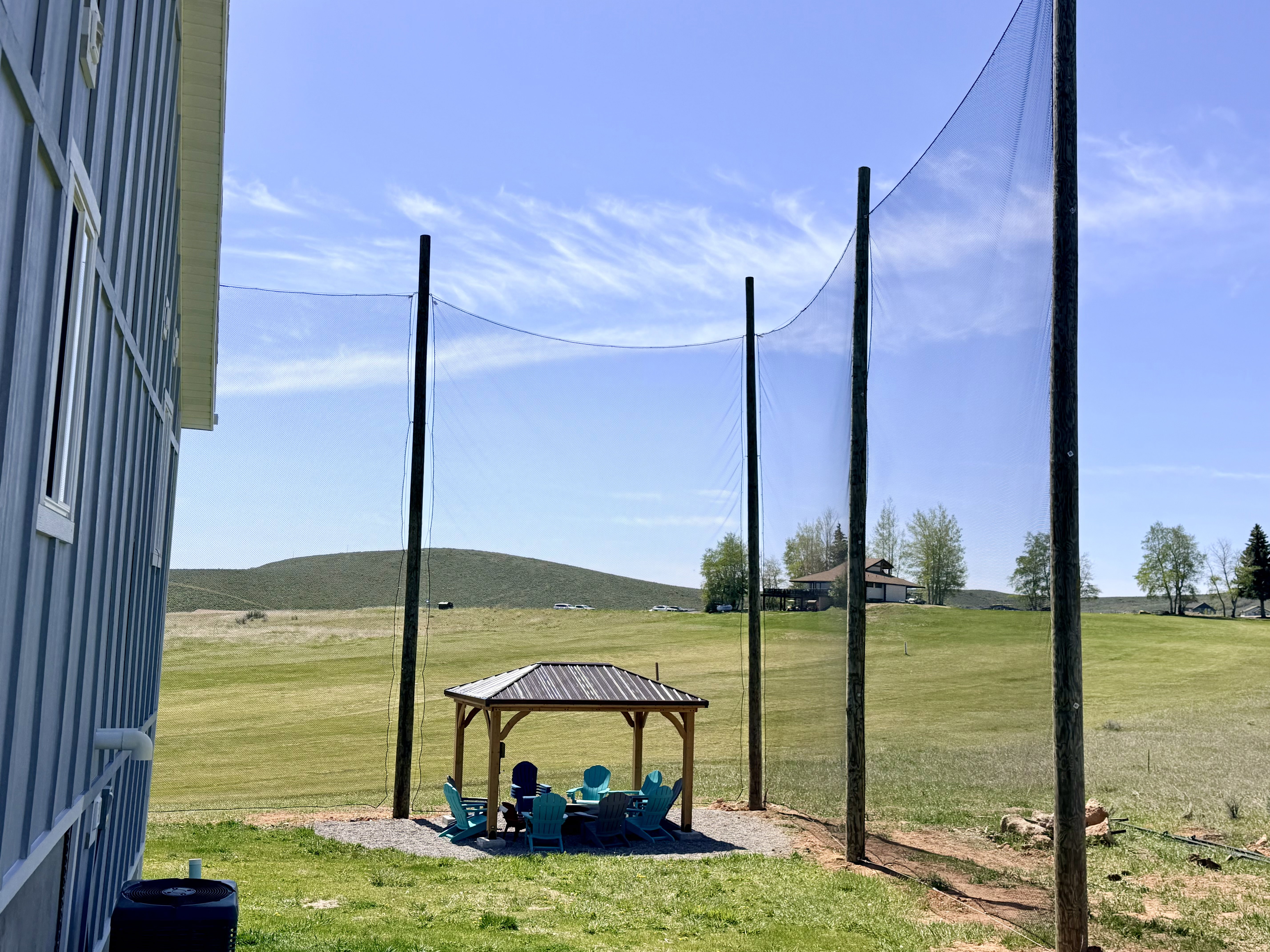 Expansive outdoor area featuring a golf netting system