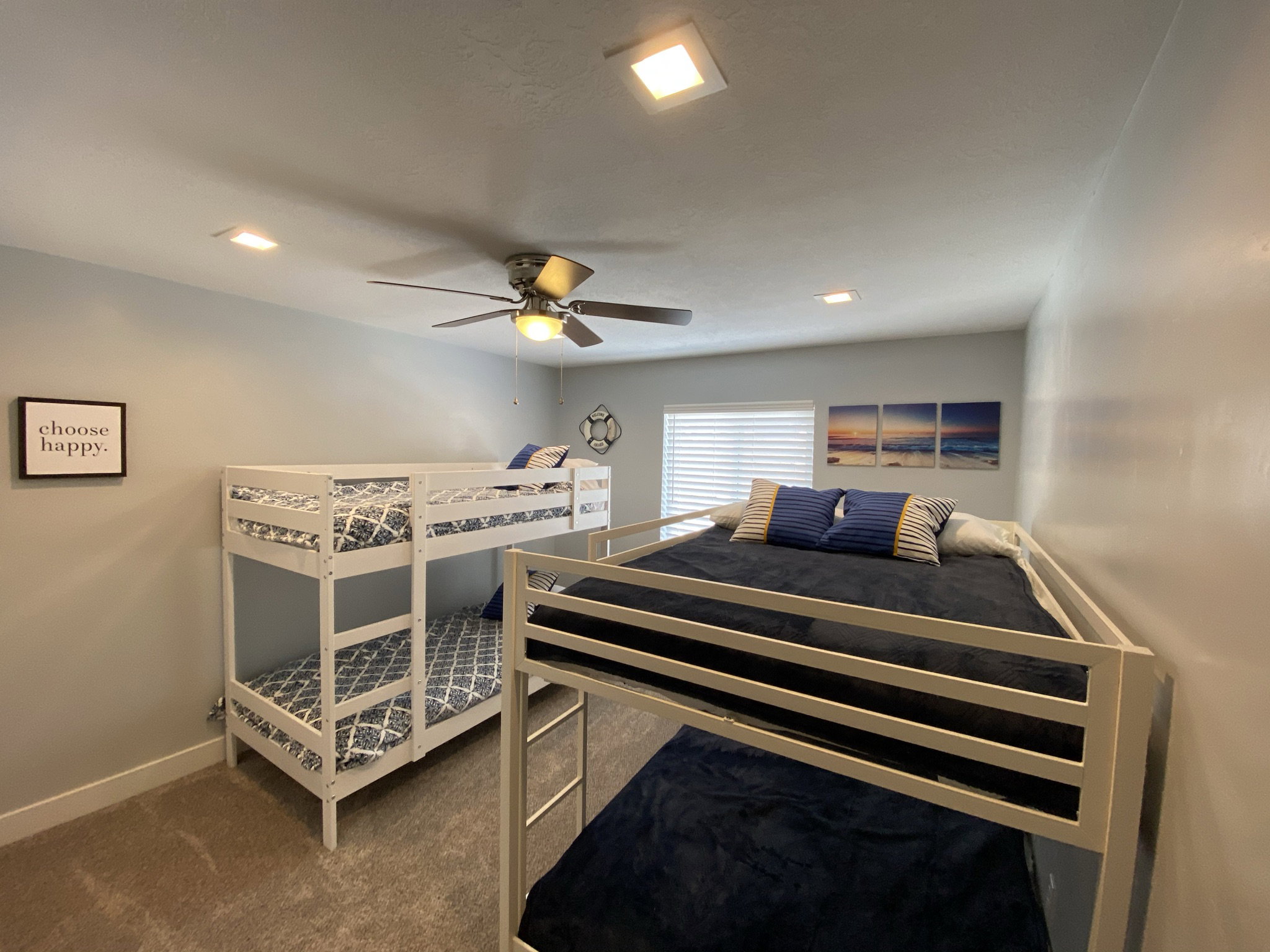 Bedroom featuring ceiling fan and carpet