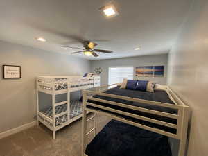 Bedroom featuring ceiling fan and carpet