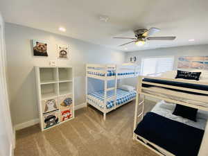 Carpeted bedroom with ceiling fan