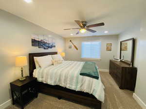 Carpeted bedroom with ceiling fan