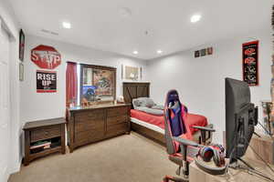 Bedroom with light colored carpet