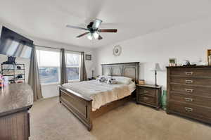 Bedroom featuring ceiling fan and large windows