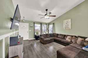 Living room with ceiling fan and vaulted ceilings