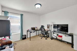 View of carpeted home office, third bedroom on main floor