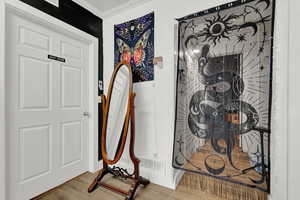 Interior details featuring wood-type flooring and ornamental molding