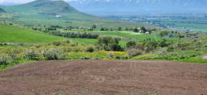 Property view of mountains with a rural view