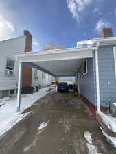 Snow covered parking with cooling unit and a carport