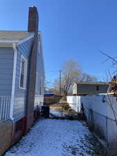 Snowy yard featuring cooling unit