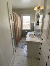 Bathroom featuring toilet, vanity, and tile patterned floors