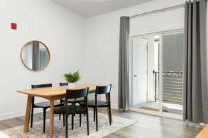 Dining area with plenty of natural light and wood-type flooring