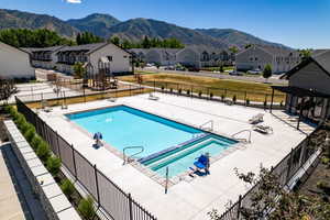 View of pool with a mountain view and a patio