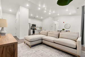 Living room featuring light wood-type flooring and lofted ceiling