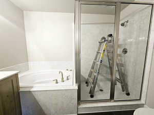 Bathroom featuring plus walk in shower and vanity