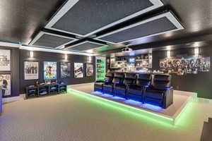 Carpeted cinema room featuring golf simulator