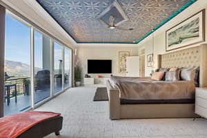 Bedroom with carpet, access to exterior, crown molding, and a mountain view