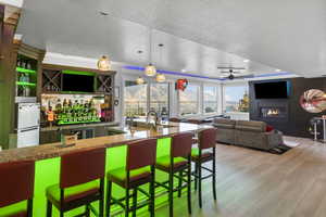 Kitchen with ceiling fan, hanging light fixtures, a textured ceiling, and white fridge