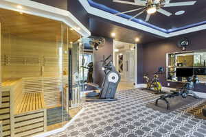 Gym with ceiling fan and carpet floors