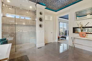 Bathroom featuring ornamental molding, a shower with shower door, and a mountain view