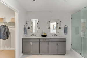 Bathroom with a shower with shower door and vanity