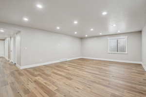 Empty room with light hardwood / wood-style flooring