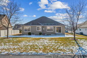 Snow covered house featuring central AC