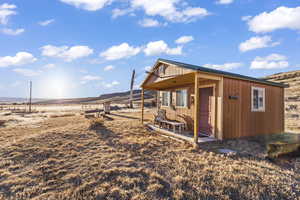 View of outdoor structure with a rural view and a mountain view