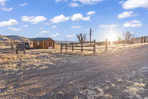 View of yard with a mountain view, a rural view, and an outdoor structure