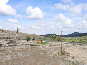 View of yard featuring a view of countryside, a mountain view, and an outdoor structure