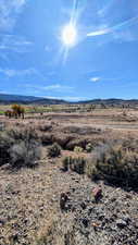 View of mountain backdrop with rural landscape