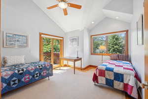 Bedroom with access to outside, ceiling fan, vaulted ceiling, and light carpet