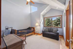 Bedroom featuring ceiling fan and lofted ceiling