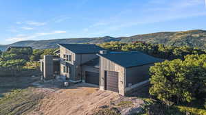 View of front facade with a mountain view and a garage