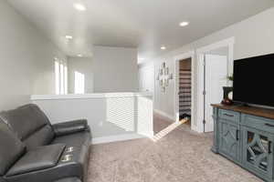 Living area featuring light carpet