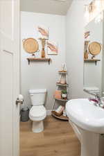 Bathroom featuring hardwood / wood-style floors and toilet