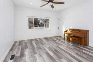 Spare room featuring light hardwood / wood-style floors and ceiling fan