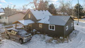 View of snow covered rear of property