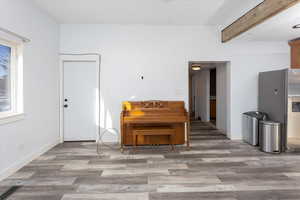 Interior space with beam ceiling and wood-type flooring