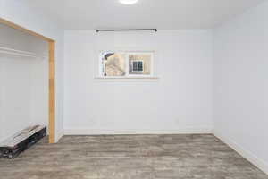 Unfurnished bedroom featuring a closet and wood-type flooring