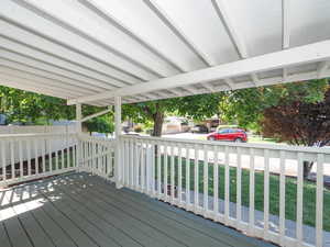 Wooden terrace featuring a yard