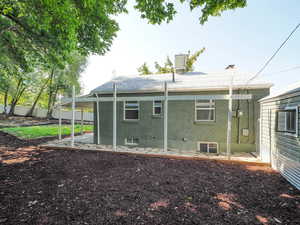 Back of house with a patio and central AC